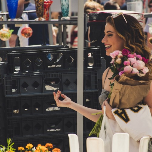 shop local farmers and artisans Woman Holding Flowers At Farmers Market